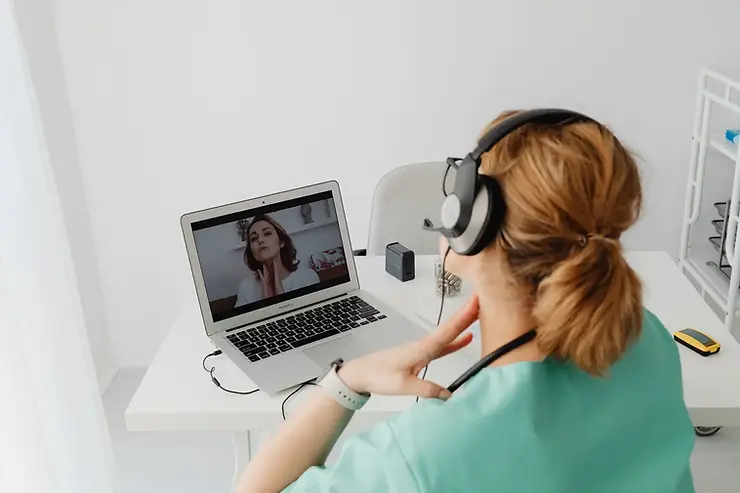 U.S. freelance assistants working remotely while wearing a headset and engaging in a video call.