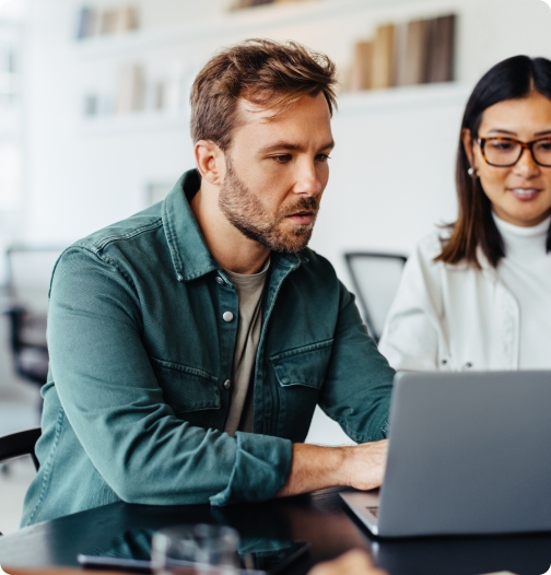 Colleagues working on a laptop computer