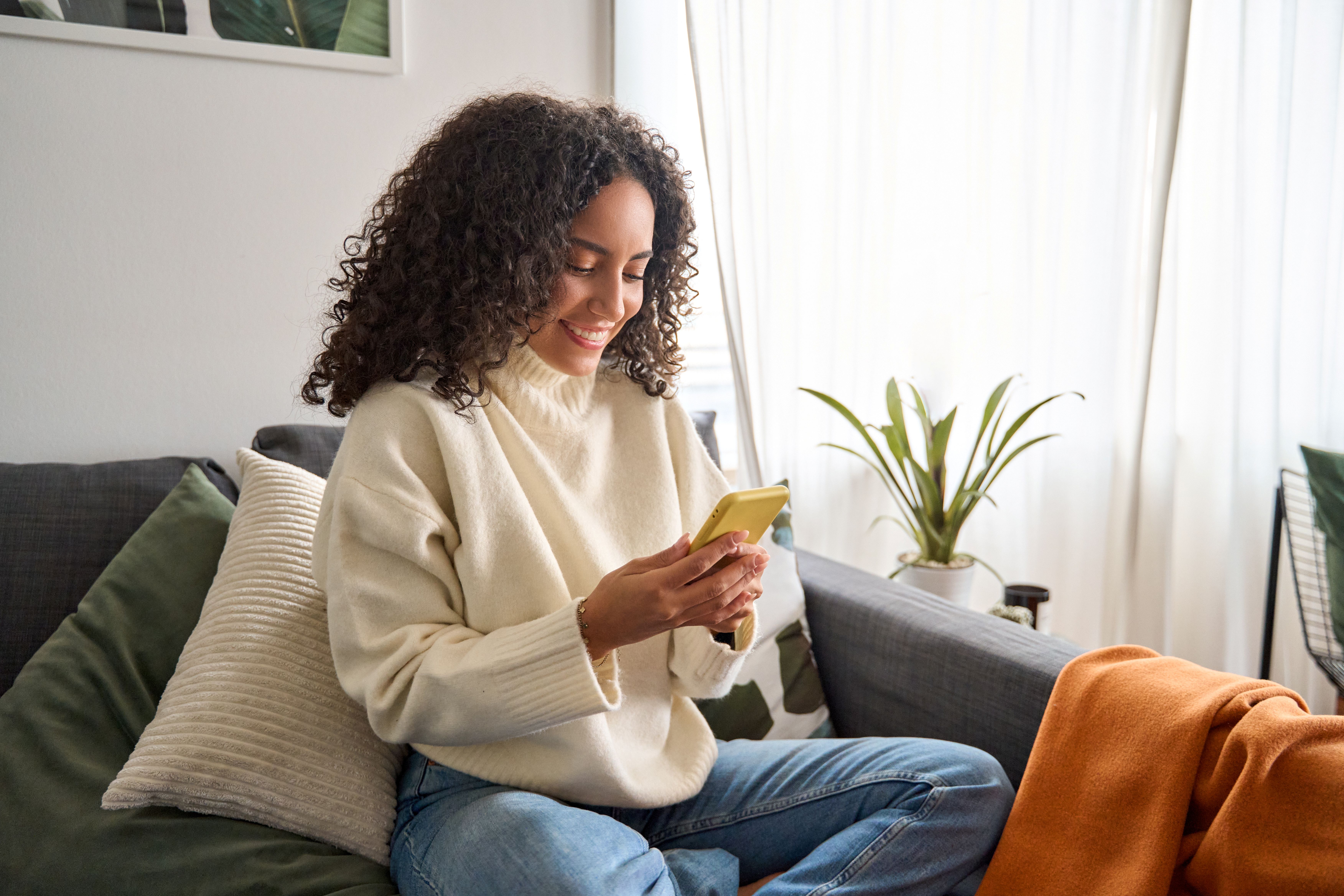 Doorly homeowner holding coffee mug in living room