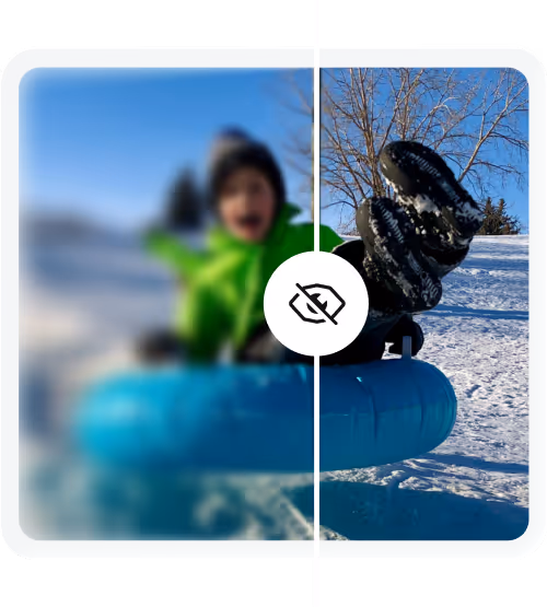 Child in green jacket snow tubing, half image blurred and half clear showing winter snow and bare tree.