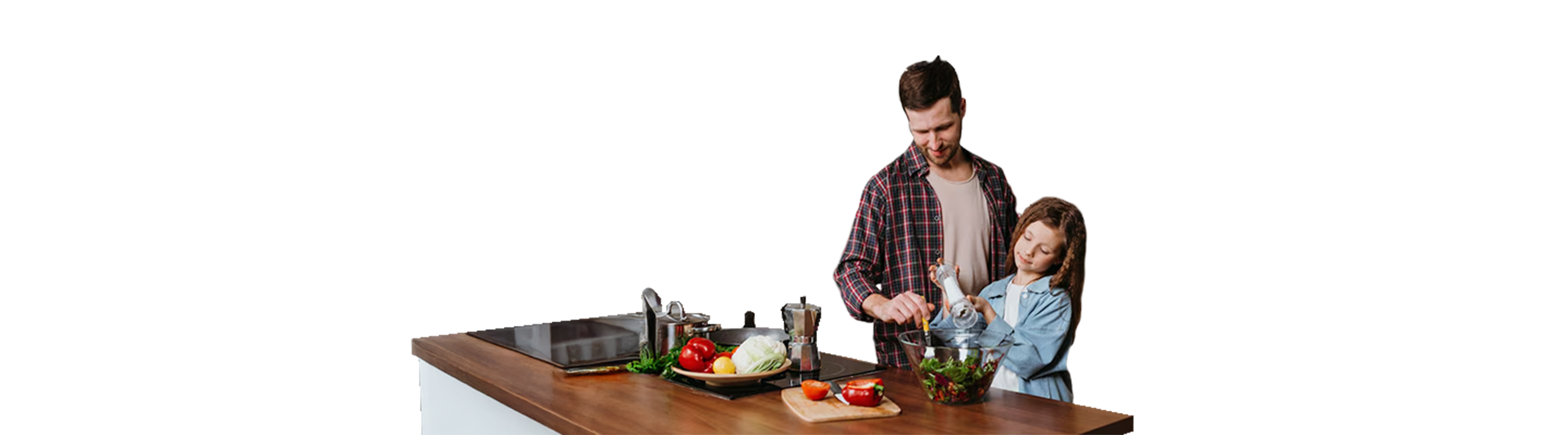 Man and young girl making a salad together on a wooden kitchen counter with vegetables nearby.