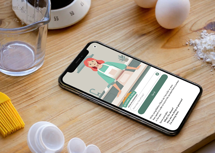 Smartphone displaying a cooking assistant app with an animated woman in an apron standing in a kitchen, surrounded by baking tools on a wooden surface.