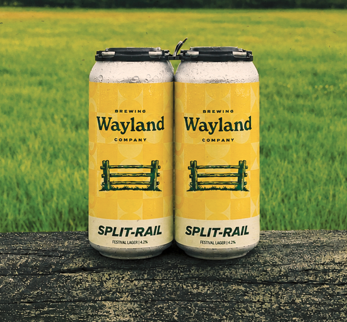 Two cans of Wayland Company Split-Rail festival lager with barbed wire fence on yellow label.