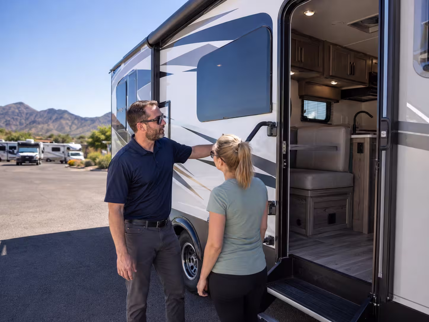 Renter reviewing a motorhome layout at a Phoenix pickup lot