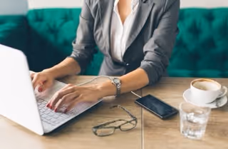 Woman downloading messages as evidence on a laptop using a secure app.
