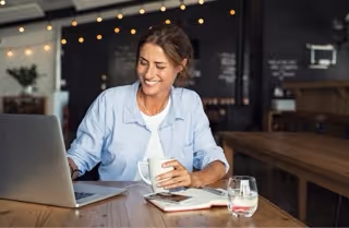 Woman reviewing text message evidence on a laptop.