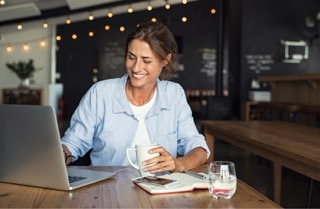Woman reviewing text message evidence on a laptop.
