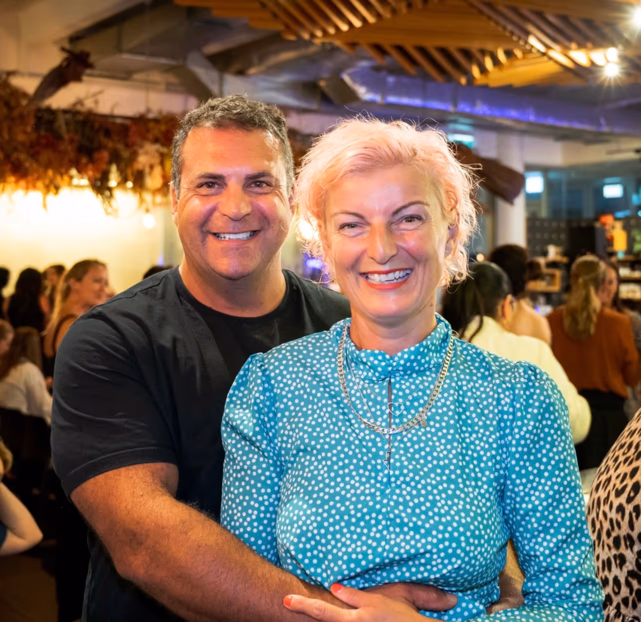Dispute Buddy founder Jenny Rudd with her husband Mathew Tomlinson, cuddling and smiling 