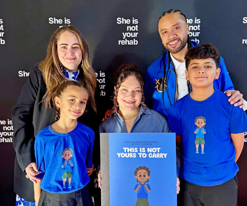Sarah Brown’s eldest child, Oceana Olsen, holds This Is Not Yours to Carry, a children’s book written by Sarah and her husband, Matt, and illustrated by Oceana.