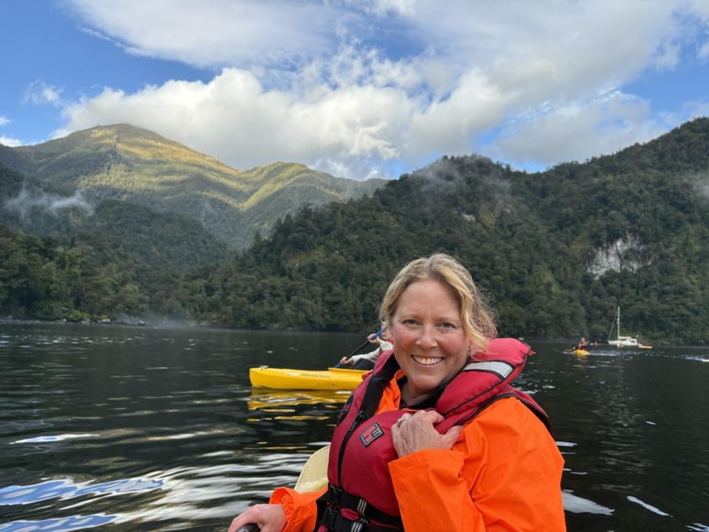 Private investigator Amy Wallace of AW Investigations smiles for a picture as she kayaks in Doubtful Sound, located in New Zealand's Fiordland National Park.