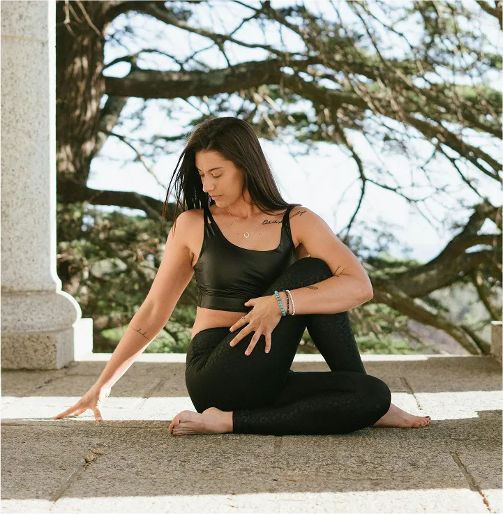 Woman practicing yoga pose in green park