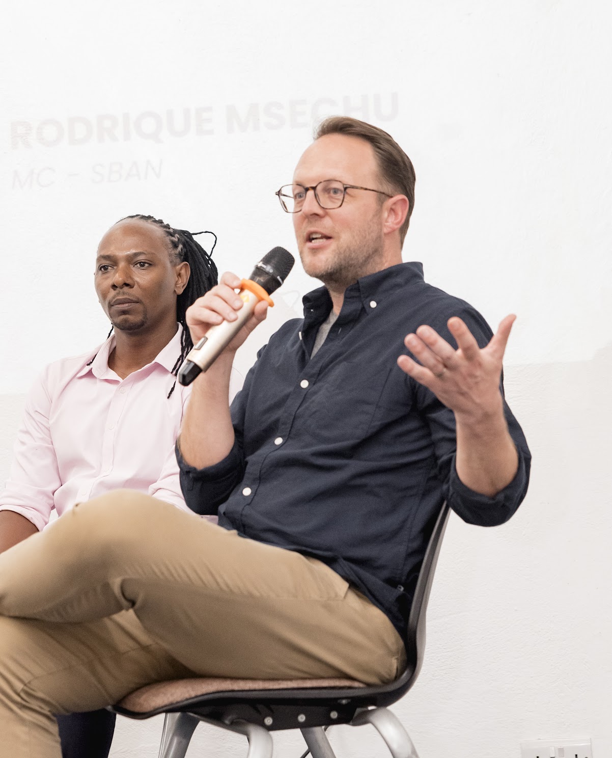 Investor speaking with participants at an event