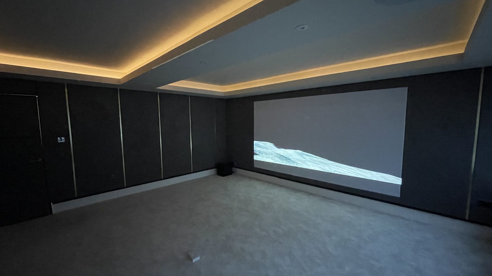 Finished Jackton garage cinema, cove lighting and screen wall