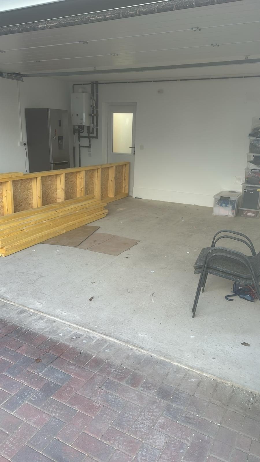 Bare garage with timber framing before conversion