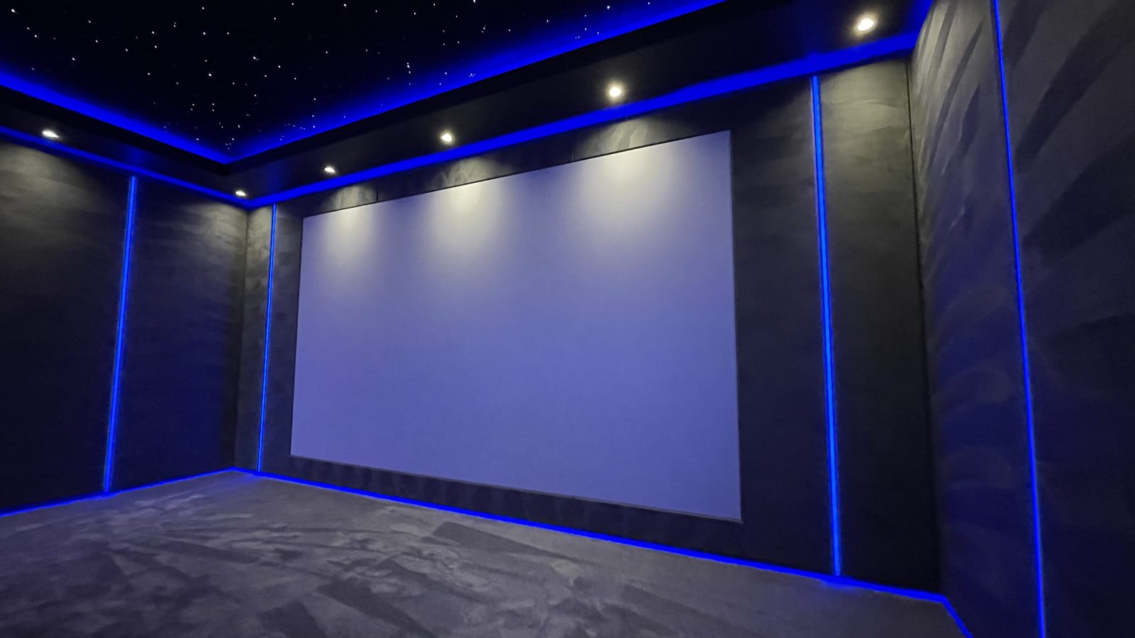 Finished dining room home cinema screen wall with blue lighting
