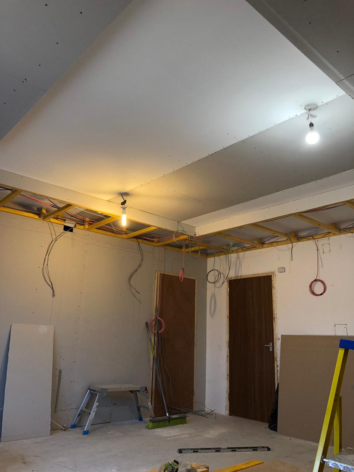 Bare garage with ceiling framing before cinema conversion