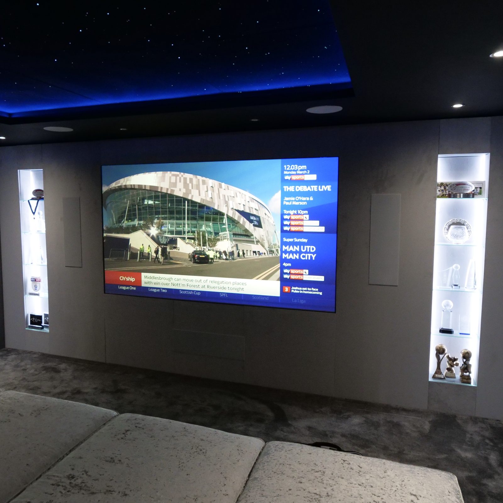 Finished Milngavie garage home cinema, screen wall with trophy display shelving