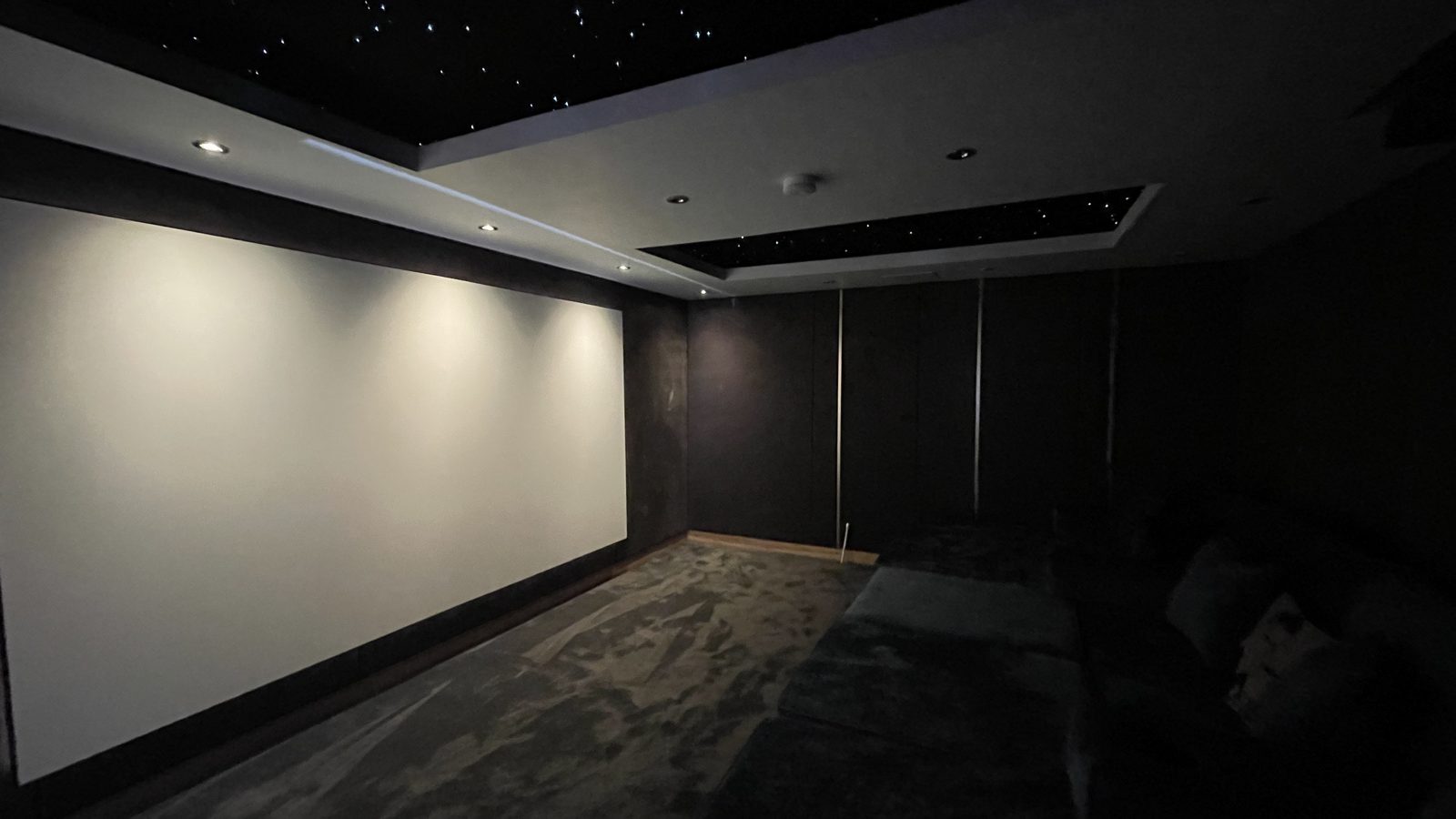 Finished spare room home cinema, screen wall with double star ceiling