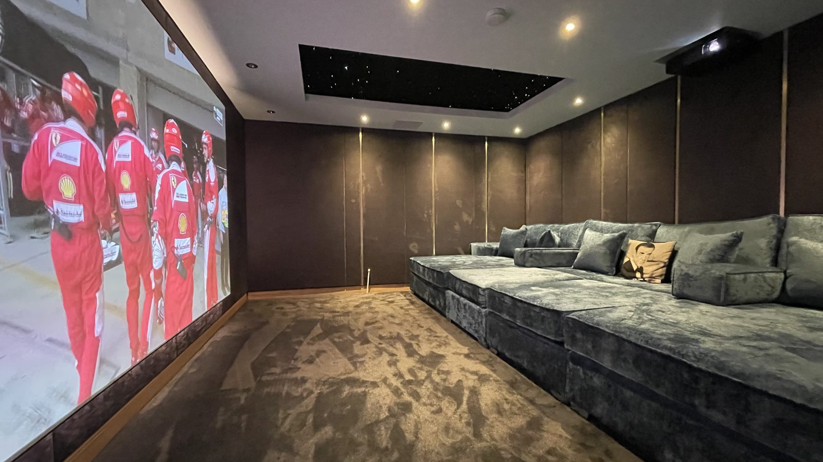 Rosebank spare room cinema, sofa and screen showing racing footage
