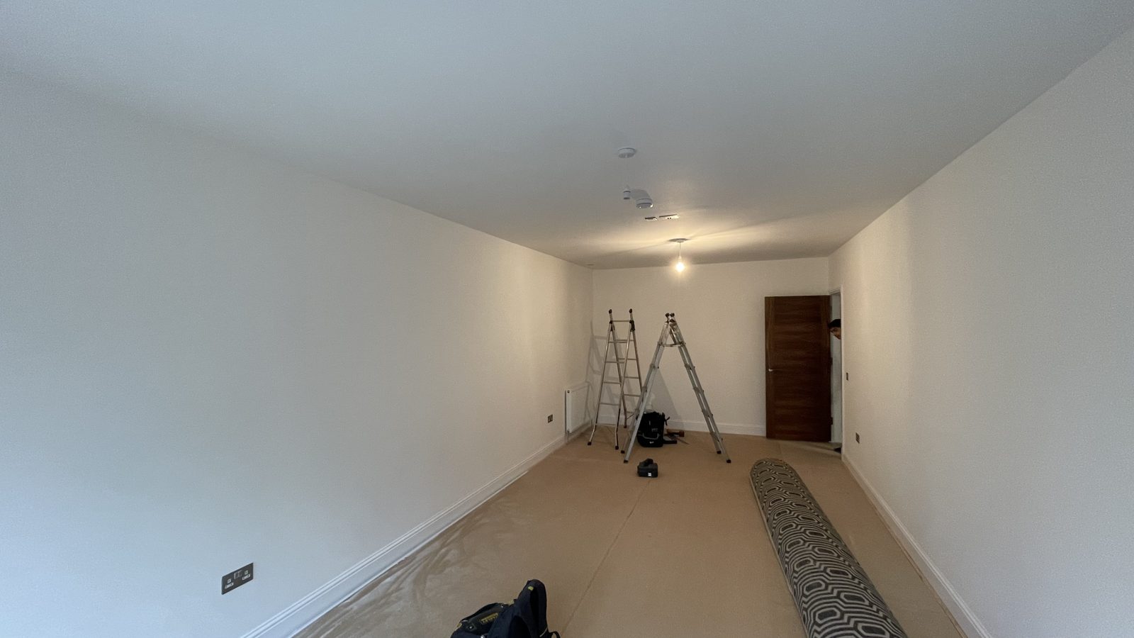 Bare penthouse room with recessed ceiling bulkhead before cinema conversion