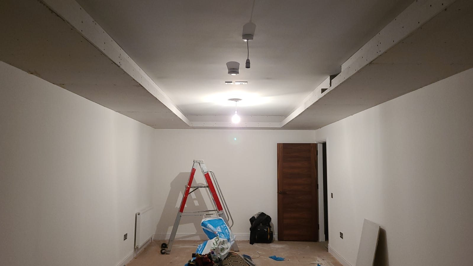 Bare penthouse room before cinema conversion, wide view