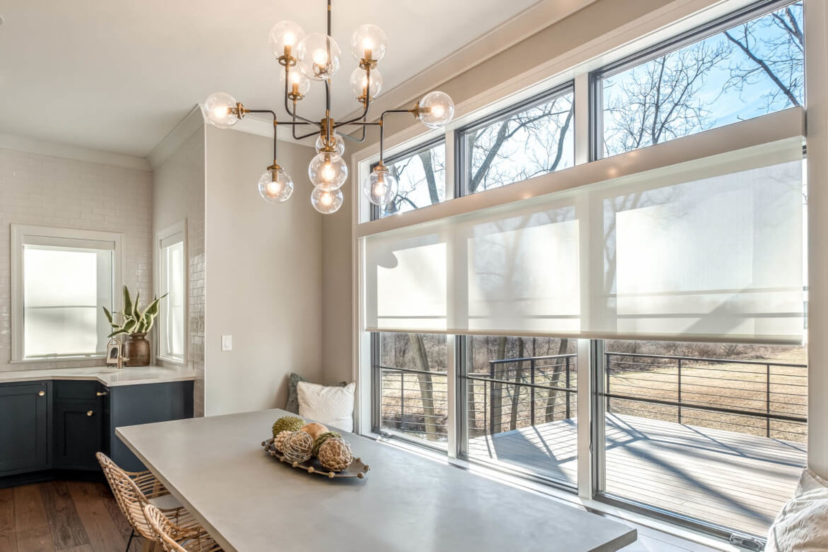 QMotion automated roller shades in a dining room, installed by Horizon Home Cinema