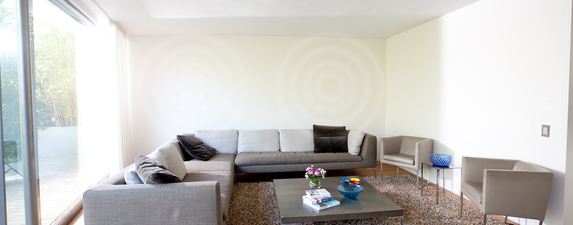 Fully invisible, plaster-in ceiling speaker installed flush into a living space ceiling, completely hidden from view
