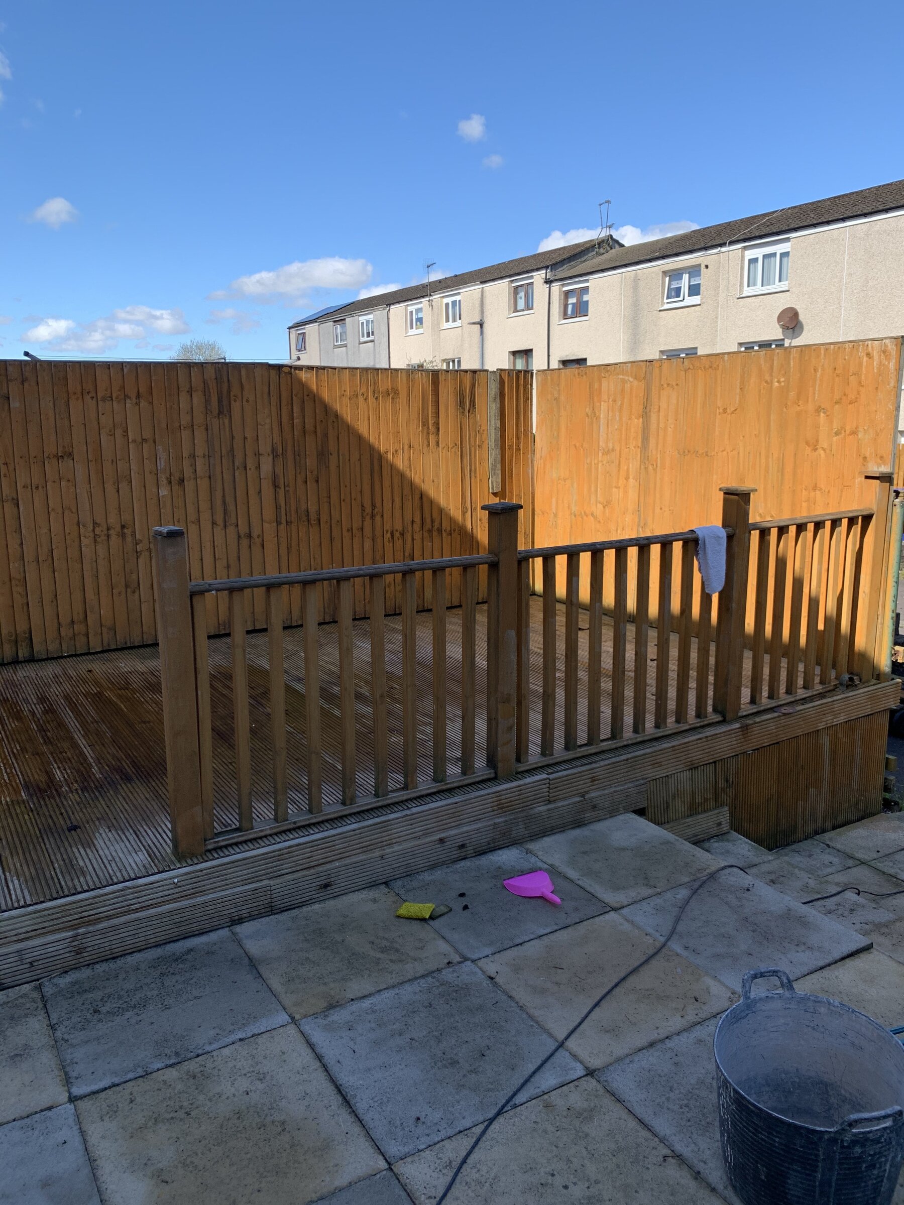 Bare timber decking and patio before garden cinema conversion