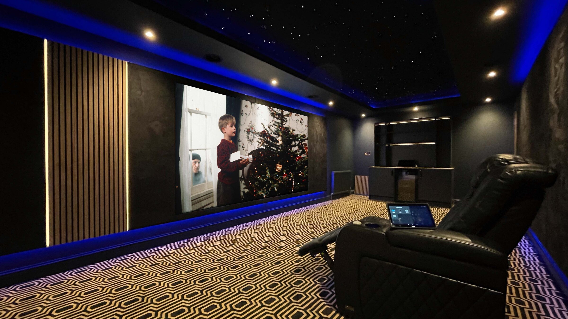 Finished Newton Mearns penthouse home cinema with wood slat feature wall and power recliners