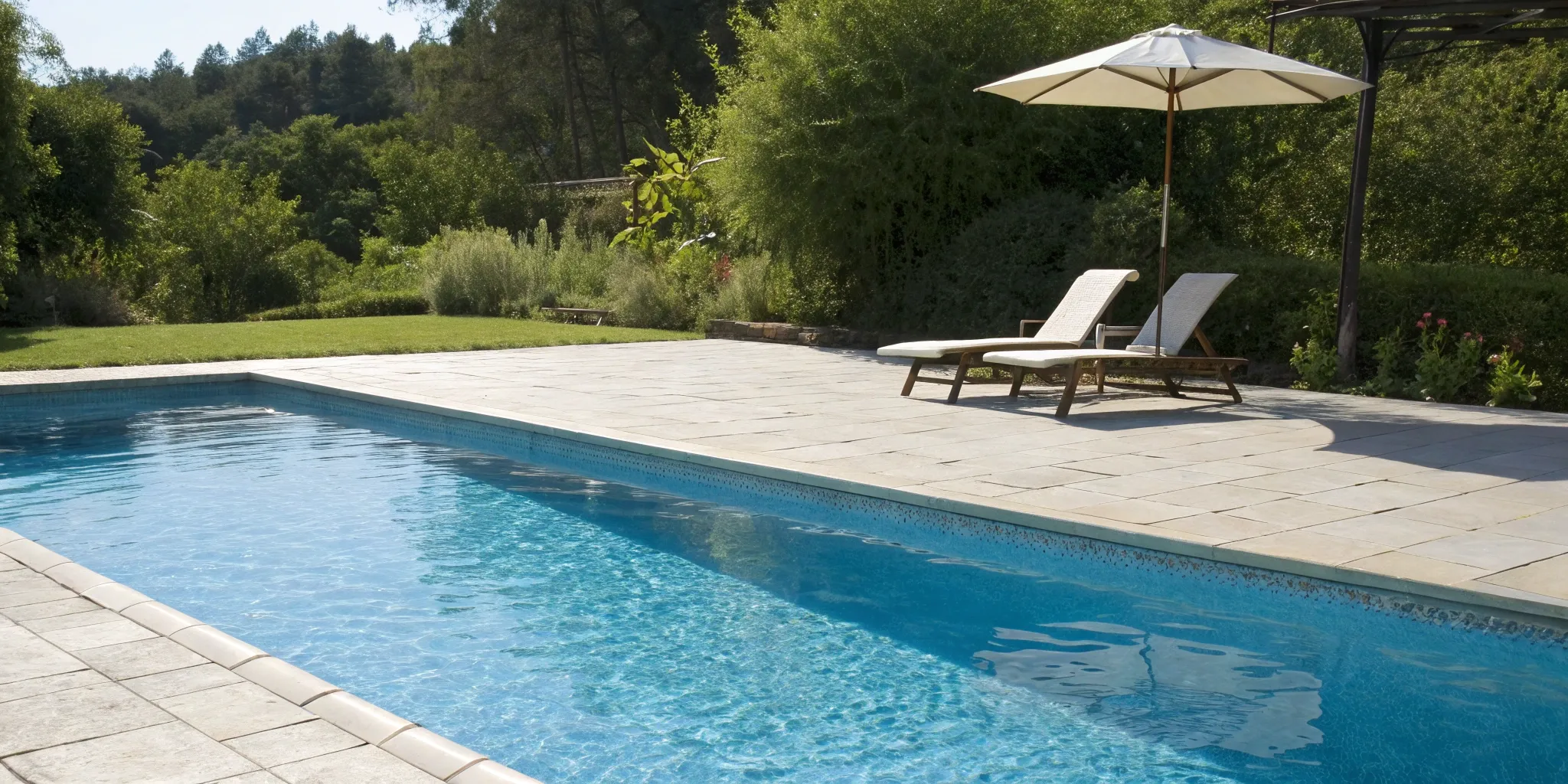 A swimming pool with perfectly clean tiles and crystal clear water after proper cleaning.