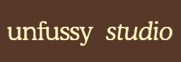 Text logo reading 'unfussy studio' with 'unfussy' in a serif font and 'studio' in italic serif font on a brown background.
