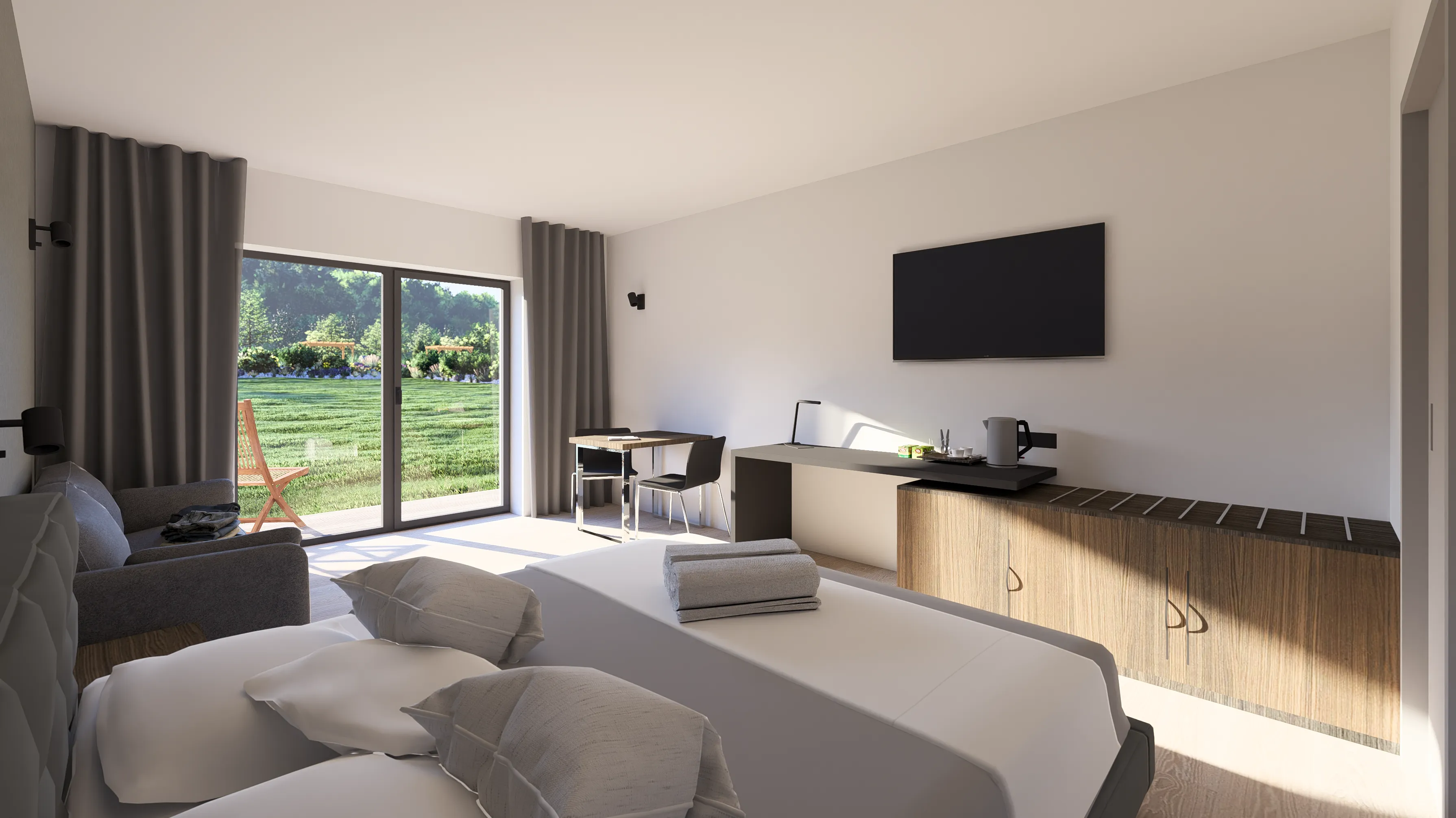 Modern hotel room with a large bed, gray sofa, desk with chairs, wall-mounted TV, and sliding glass doors opening to a green lawn.