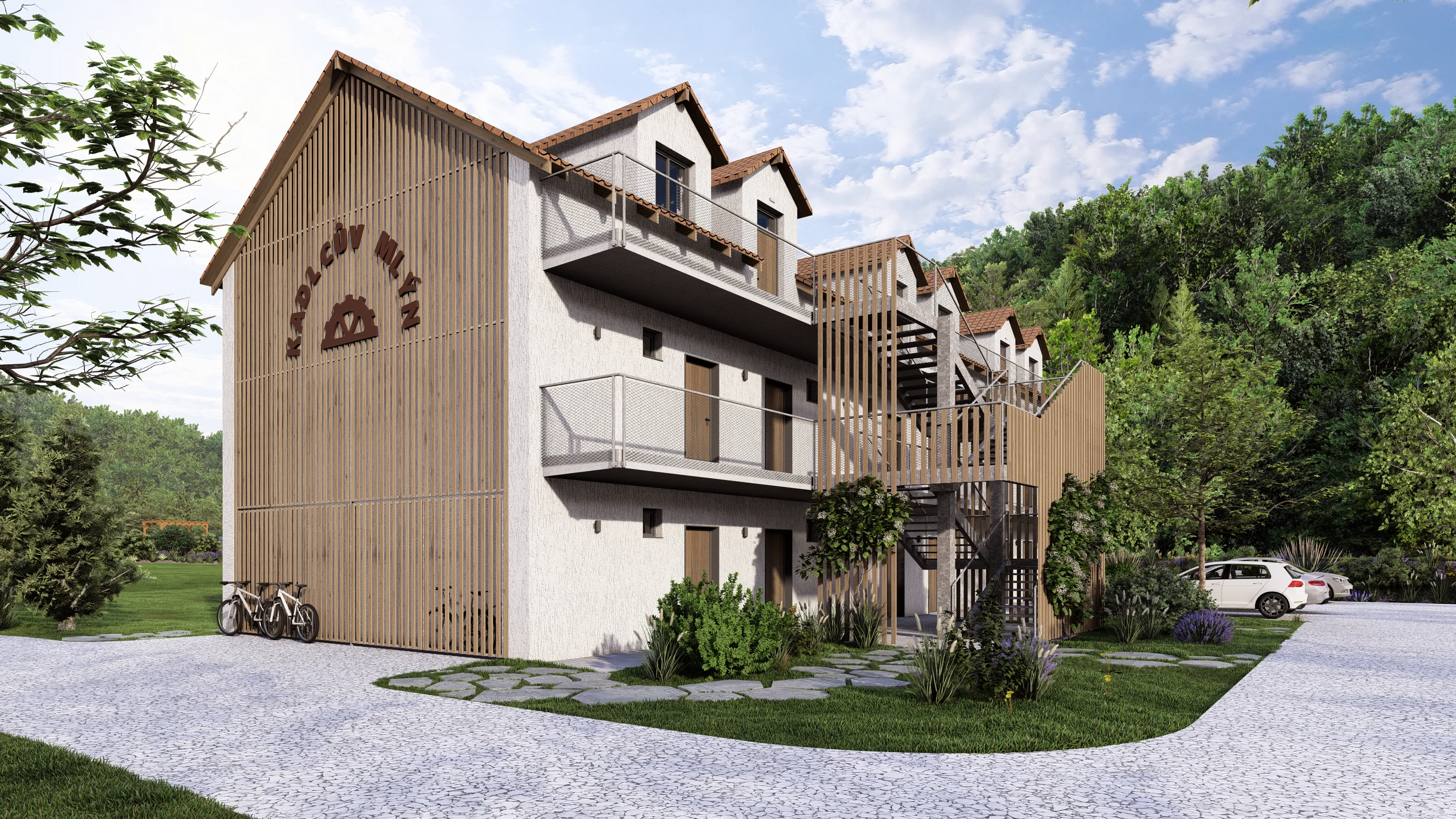 Three-story modern building with wooden exterior accents, outdoor metal staircases, surrounded by trees and a parking area with cars and bicycles.