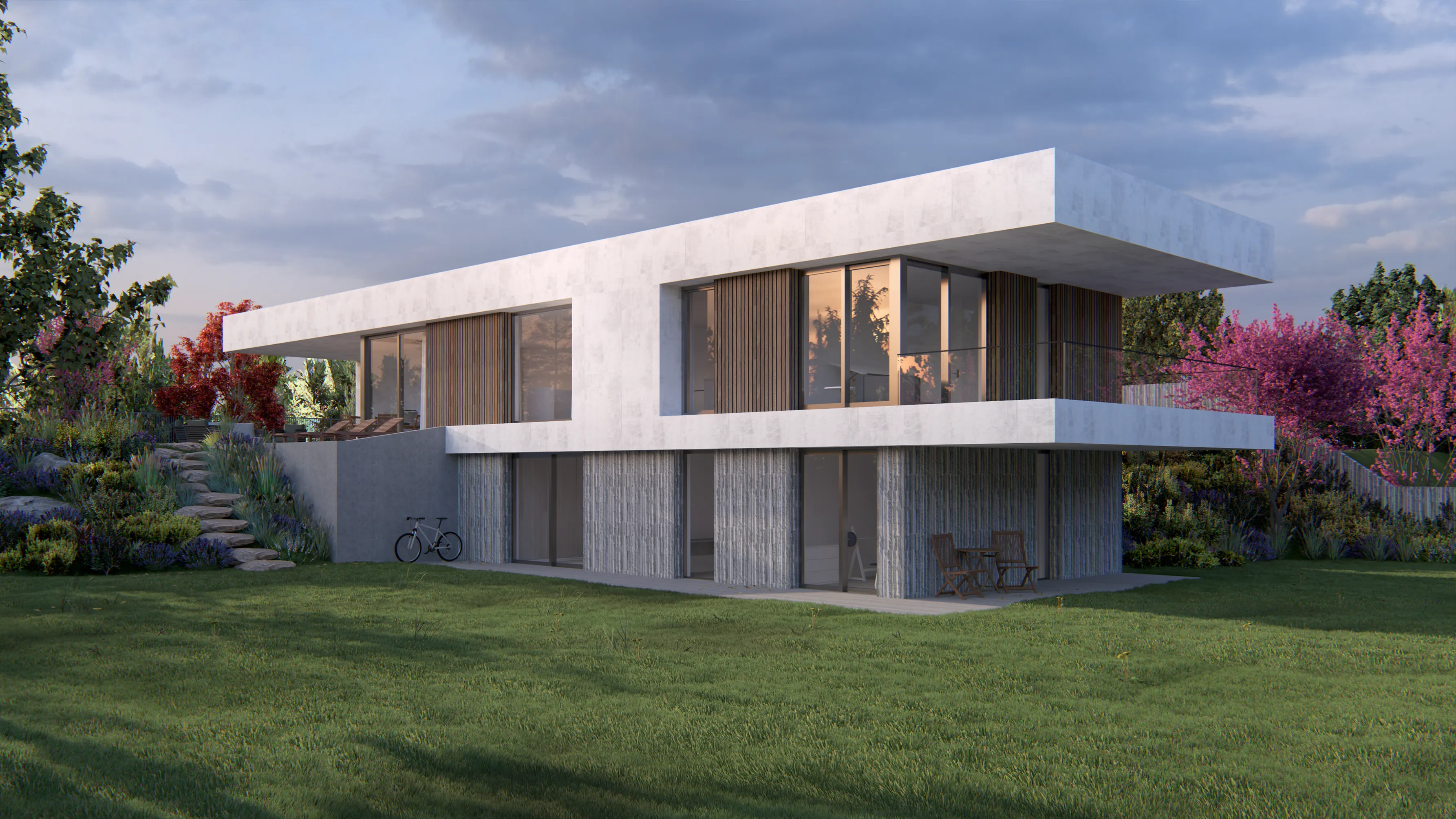 Modern two-story house with large glass windows, wooden accents, surrounded by green lawn and colorful trees at sunset.