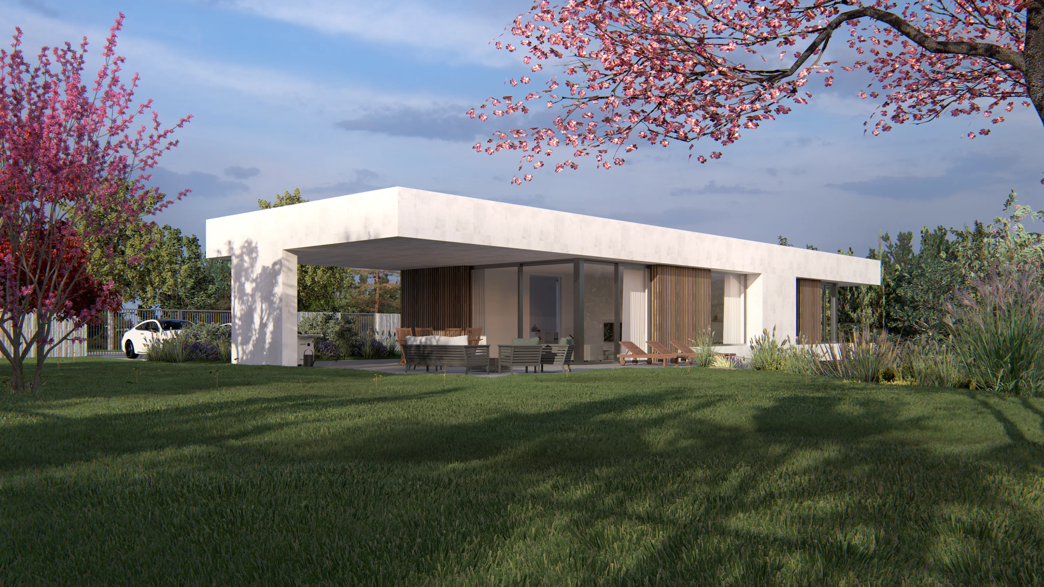 Modern single-story house with flat roof and large glass windows, surrounded by green lawn and flowering trees under a cloudy sky.