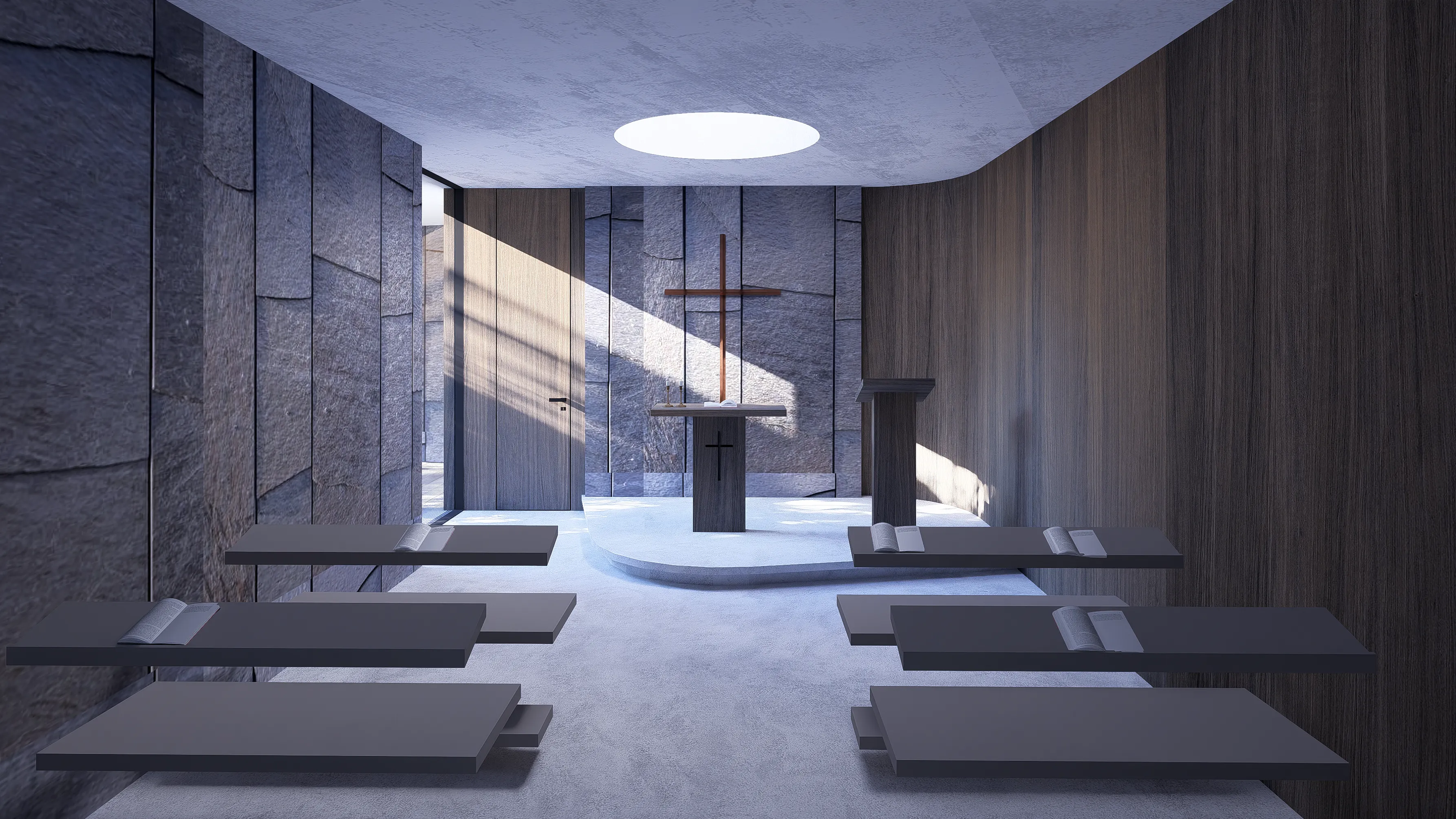 Modern chapel interior with stone walls, floating benches, a wooden altar with a cross, and a circular skylight above.