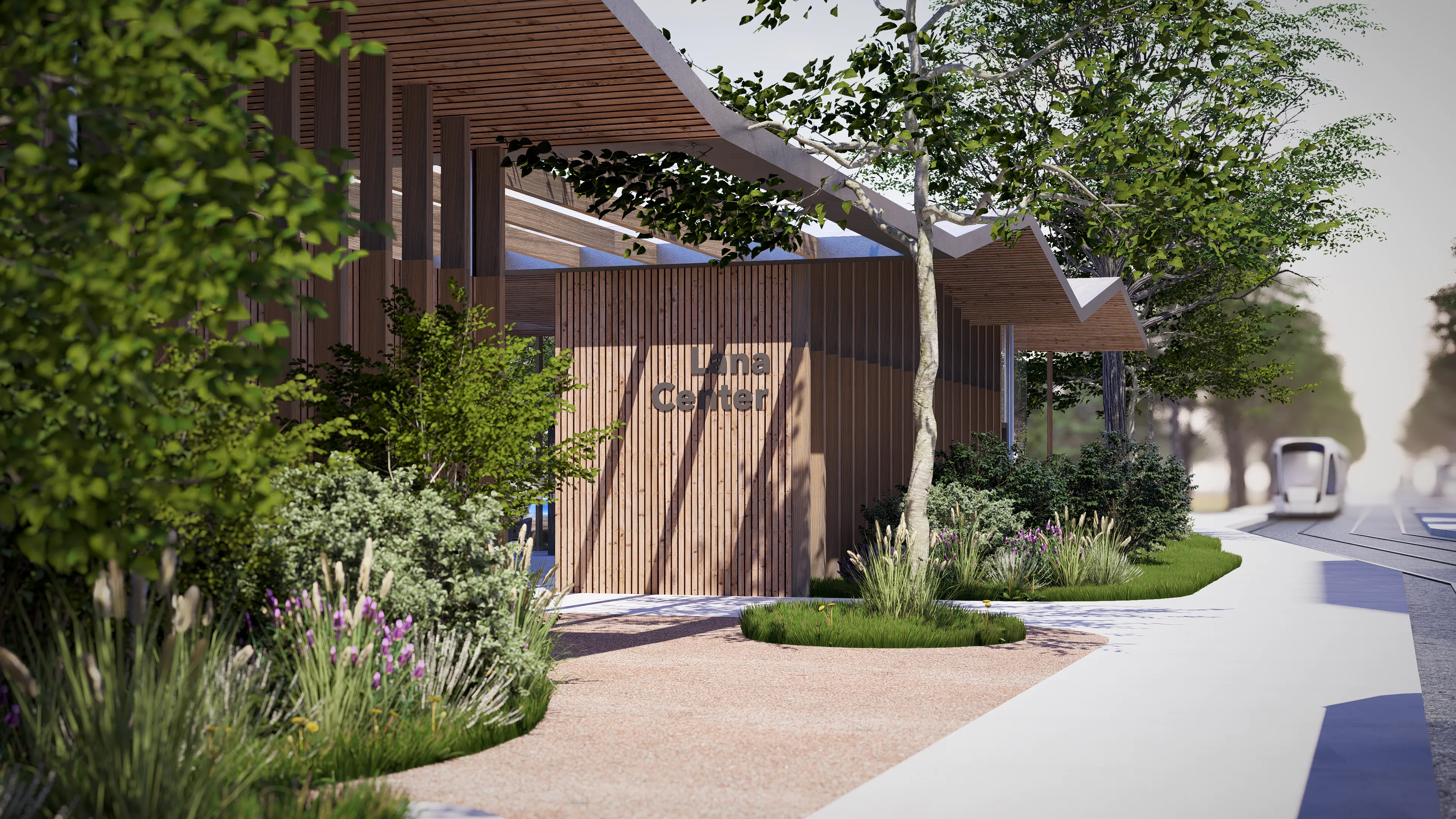Two-story white residential building with dormer windows, a brown gable roof, a wooden side facade, surrounded by green trees and parked cars.