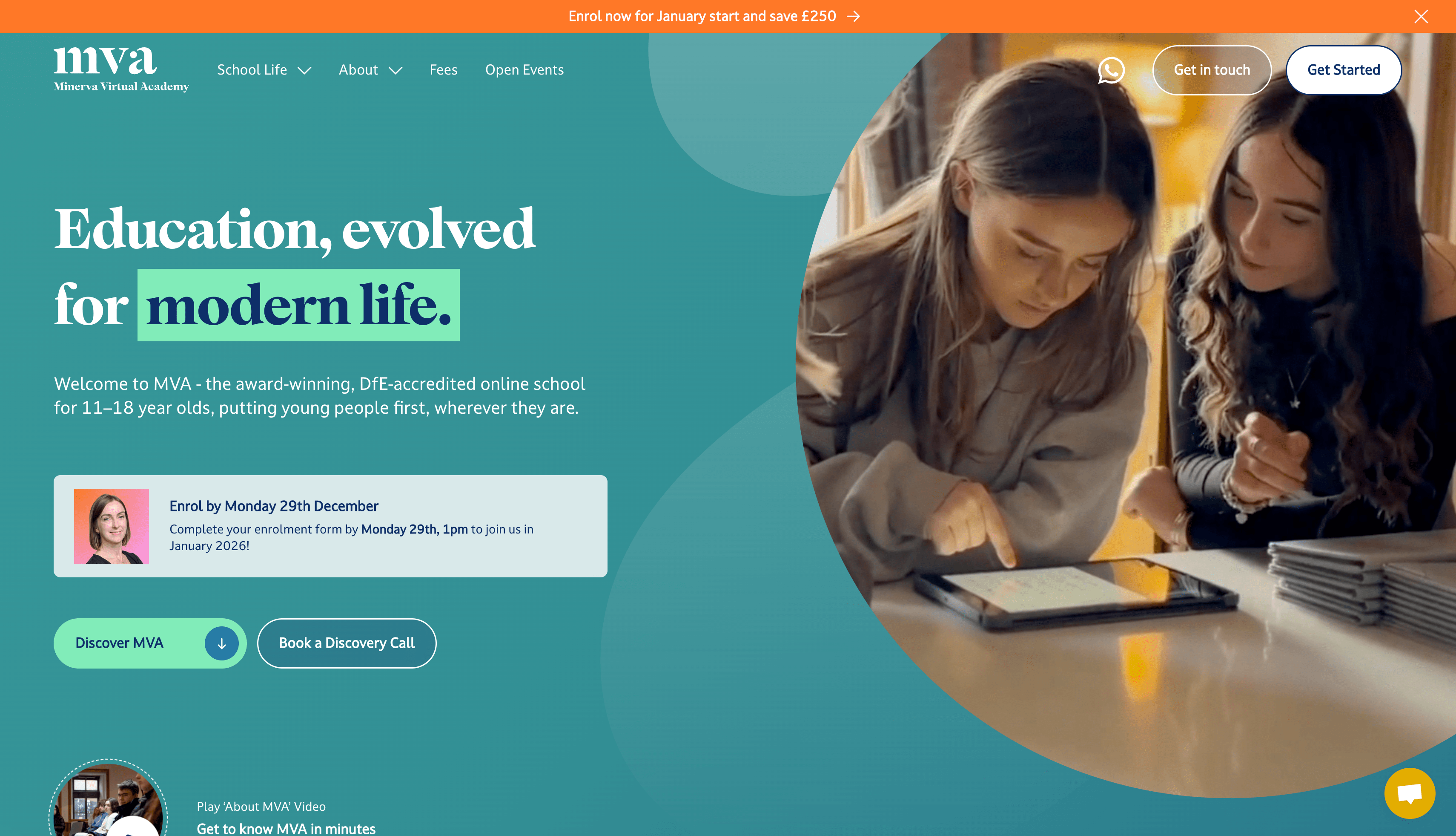 Two young people looking closely at a tablet on a table in a cozy indoor setting.