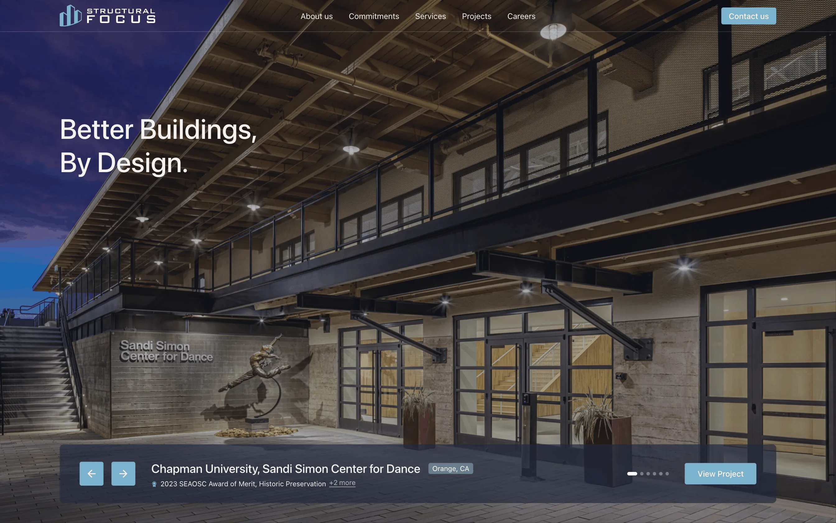 Evening view of Chapman University's Sandi Simon Center for Dance with modern architectural design and a dance statue near the entrance.