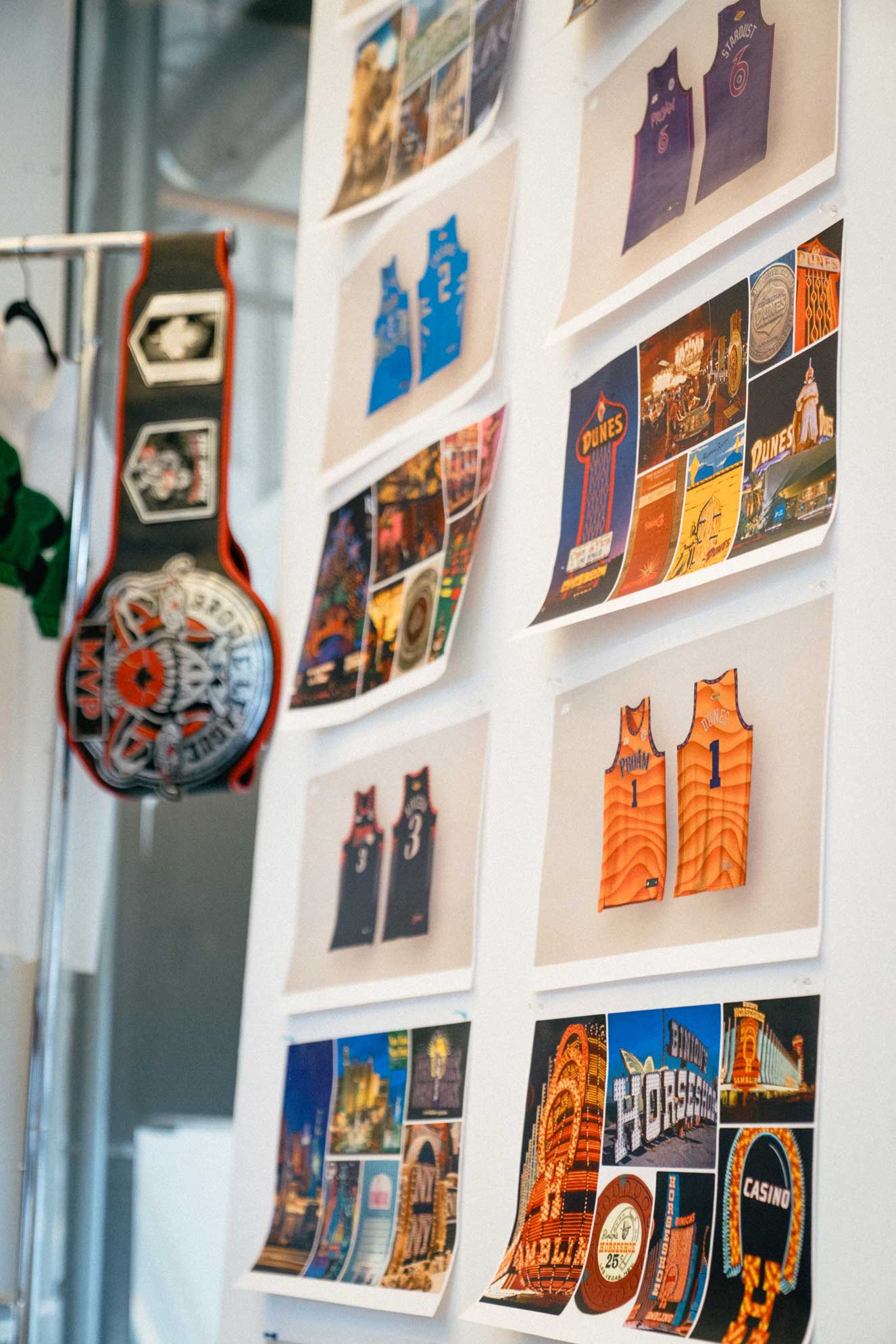 Brodie Rec League office wall displaying printed game day photos, basketball artwork, and league championship belts