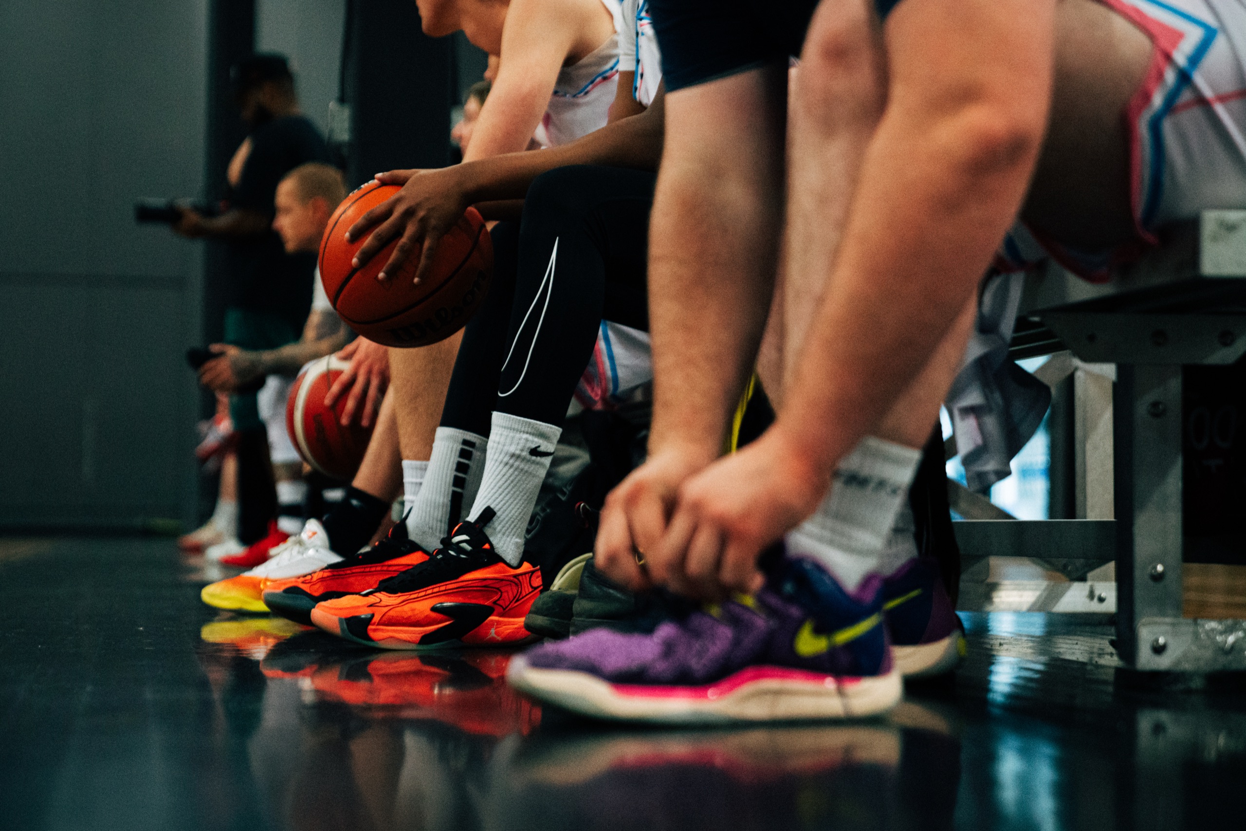 Basketball shoes lined up on the court before a Brodie drop-in game