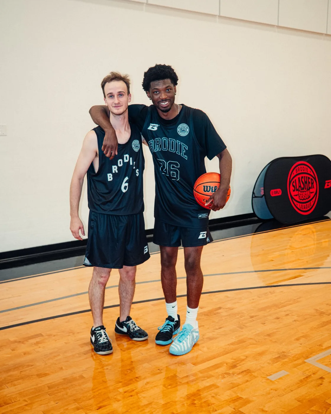 Two friends arm in arm in Brodie jerseys