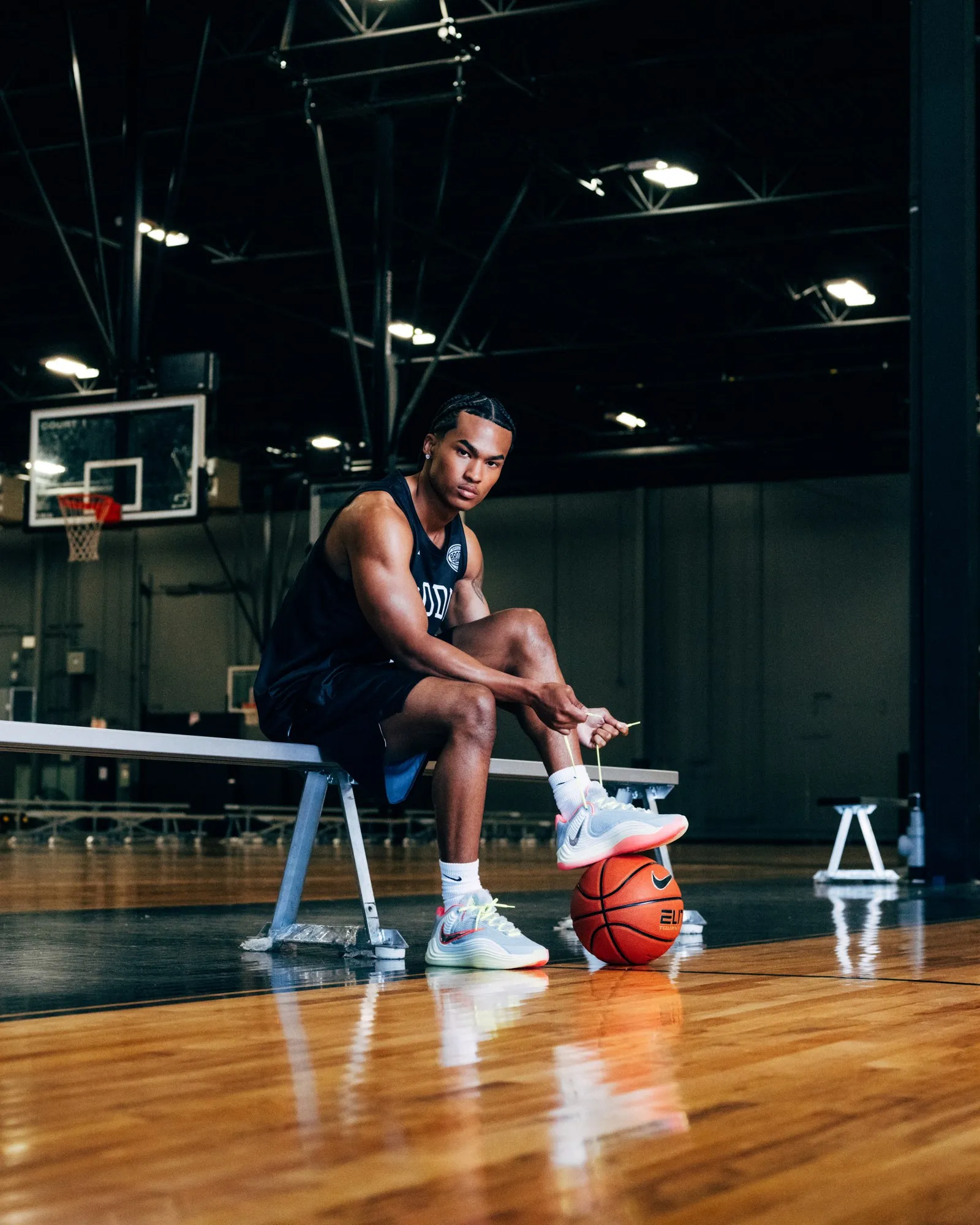 Brodie athlete tying his shoes courtside before his first game