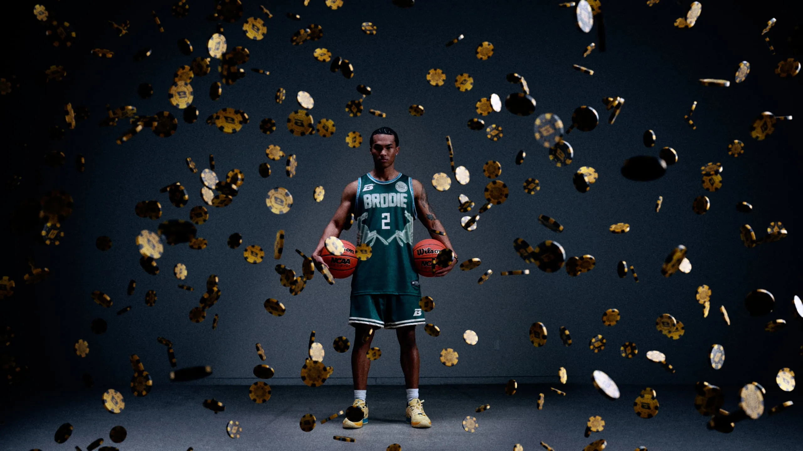 Brodie athlete holding two basketballs as gold coins fall around him