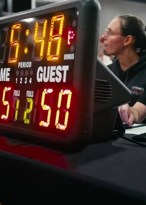 Shot clock and scorekeepers at a Brodie game night