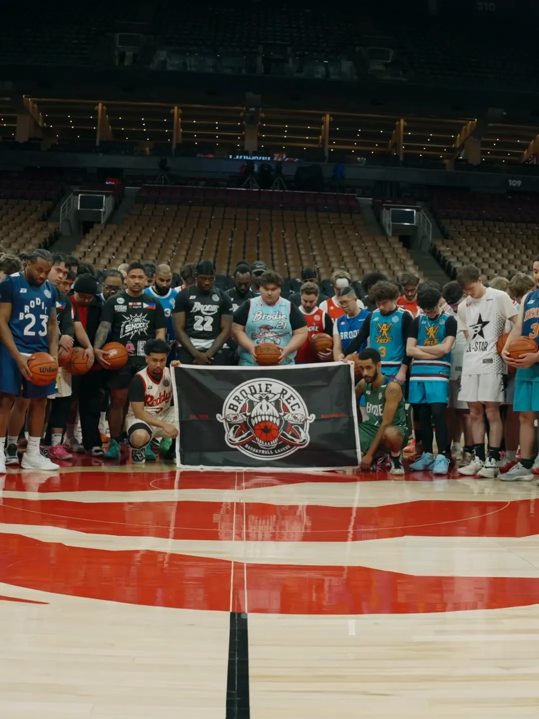 Brodie athletes on the Raptors court at Scotiabank Arena behind the Brodie Rec banner