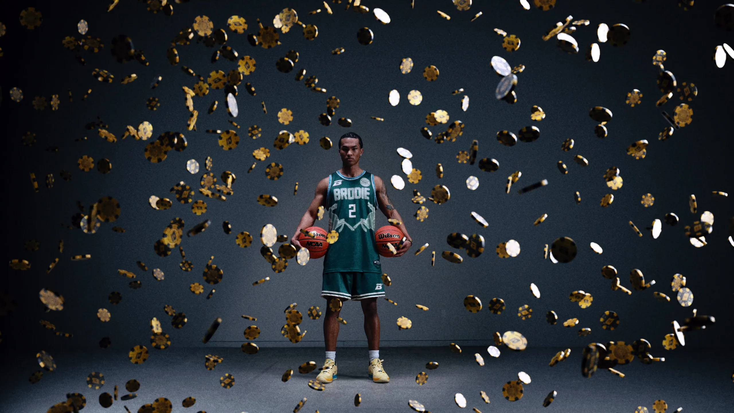 Brodie athlete holding two basketballs as gold coins fall around him