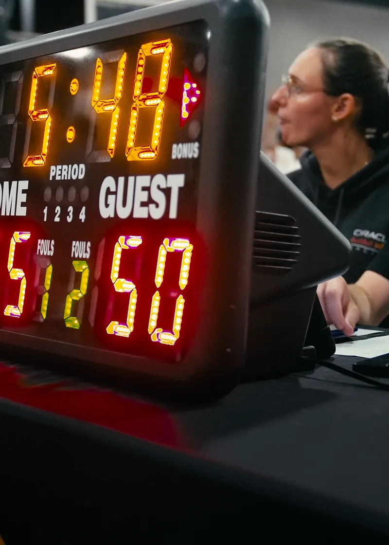 Shot clock and scorekeepers at a Brodie game night