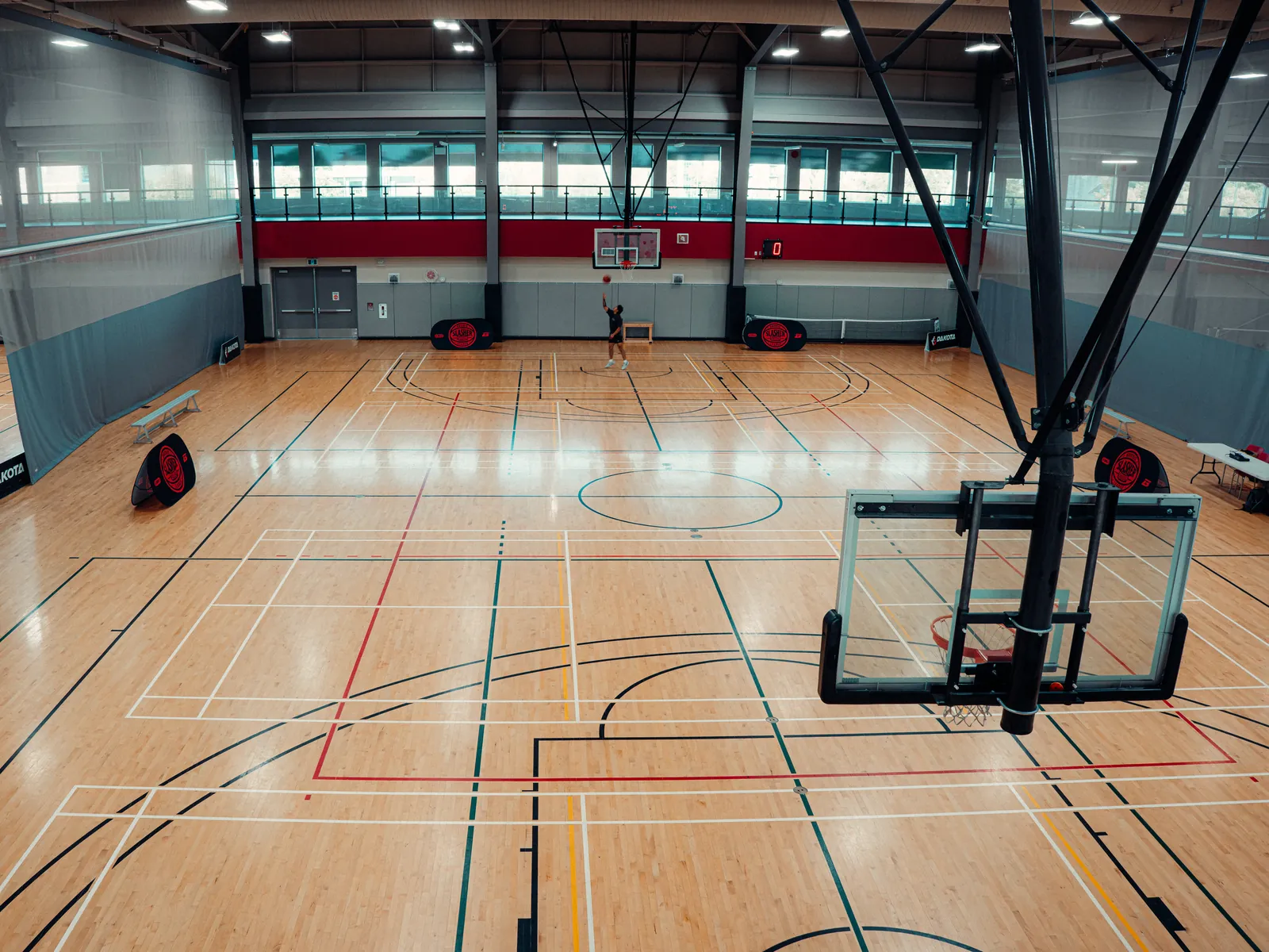 Empty multi-court gym with hardwood floors