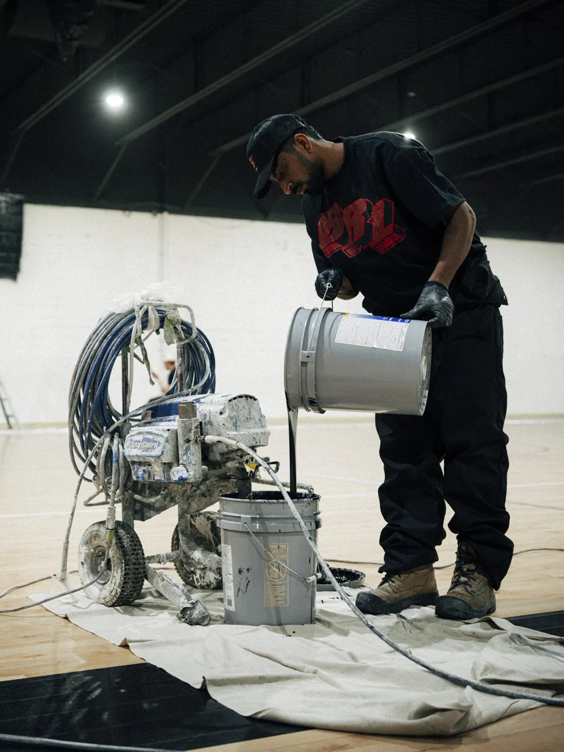 BRODIE crew setting up gear on a venue floor